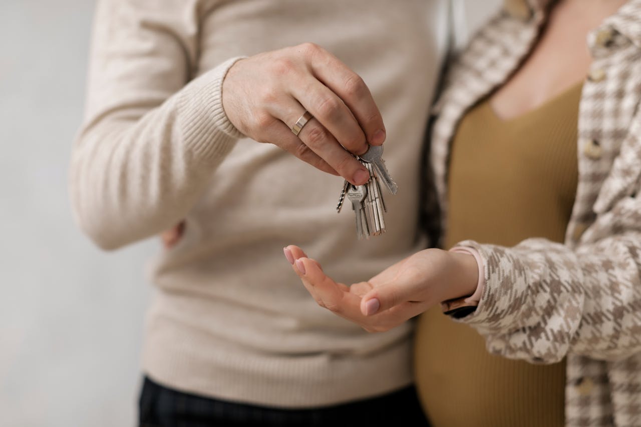 Couple holding keys to their new home — cohabitation solicitors London